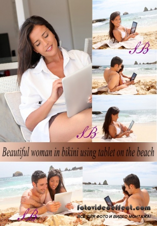 Stock Photo: Beautiful woman in bikini using tablet on the beach