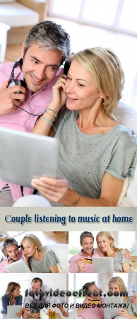 Stock Photo: Couple listening to music at home with tablet