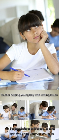 Stock Photo: Teacher helping young boy with writing lesson