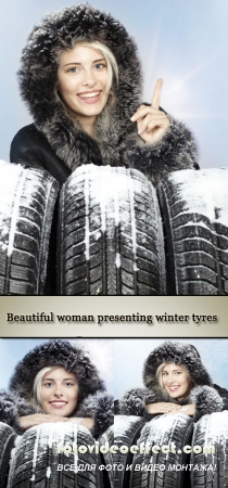 Stock Photo: Beautiful woman presenting winter tyres