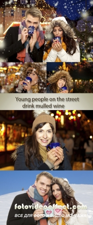Stock Photo: Young people on the street drink mulled wine