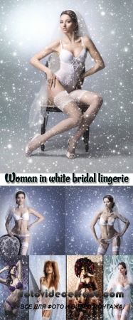 Stock Photo: A young woman in white bridal lingerie on a snowy background