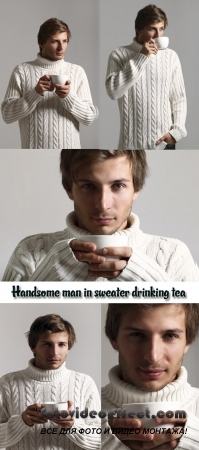 Stock Photo: Young man in a white sweater drinks hot tea