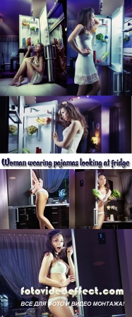 Stock Photo: Woman wearing pajamas looking at fridge
