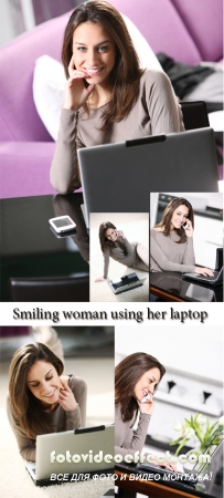 Stock Photo: Smiling woman using her laptop in the living room