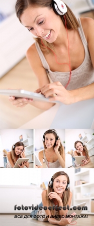 Stock Photo: Smiling young woman listening to music