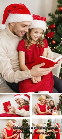 Stock Photo: Smiling family reading book