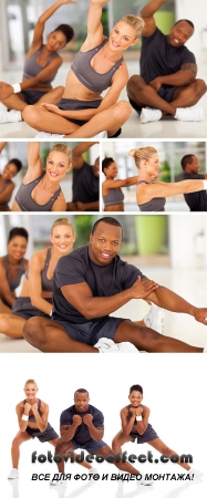 Stock Photo: Fit woman stretching with friends